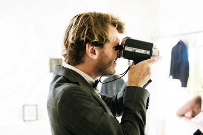 A friend captures the bride and groom getting ready with a Super 8 camera