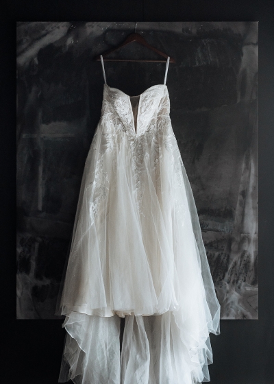 a white wedding dress hangs on the wall in an Airbnb in Tasmania